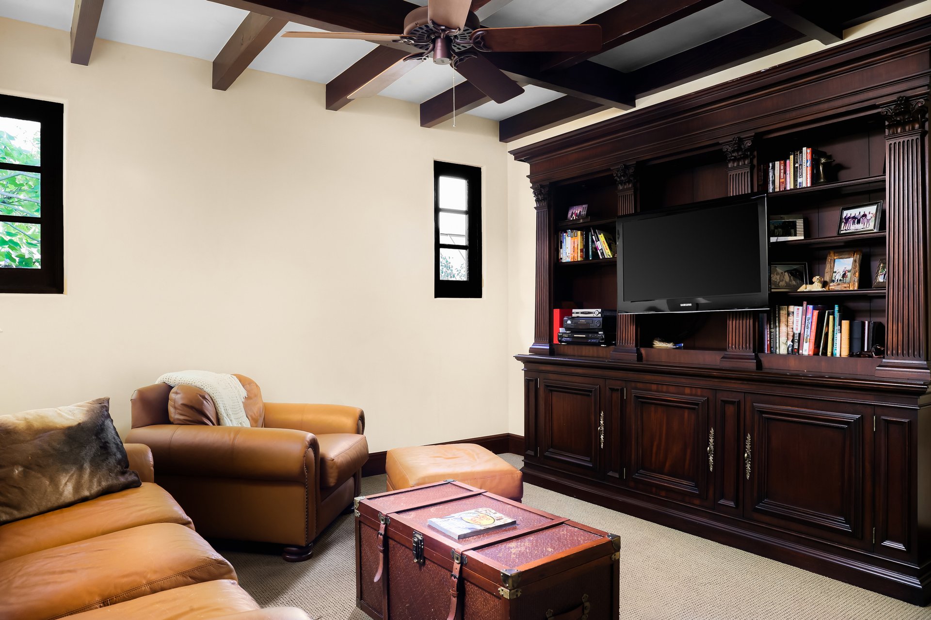 Media room with leather seating and built-in mahogany cabinetry